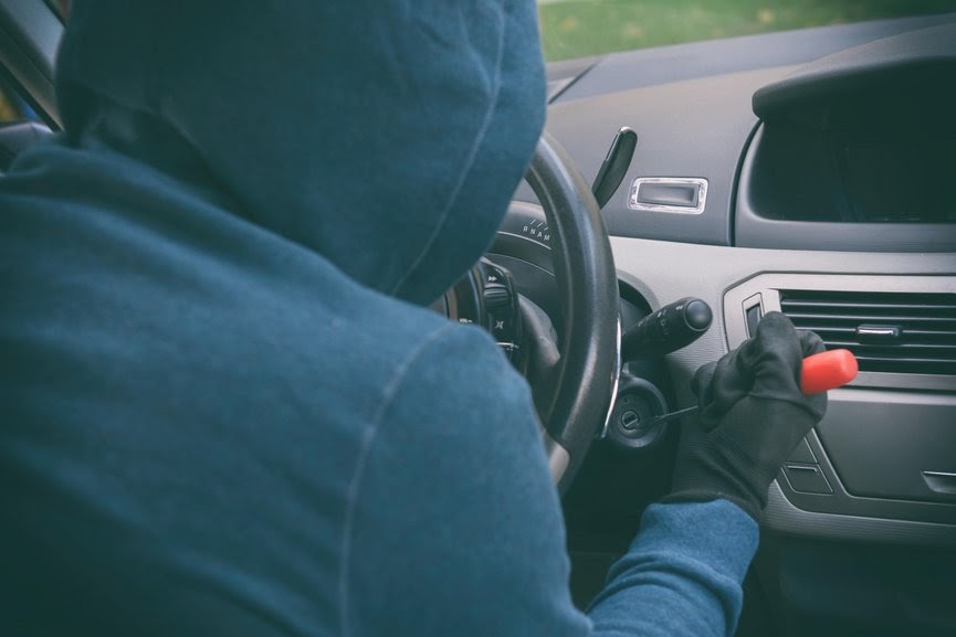 Photo of car thief stealing a vehicle