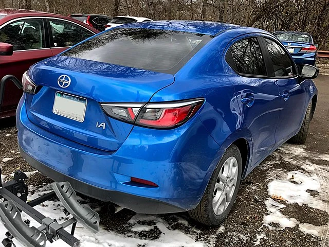 Blue Scion iA on a street