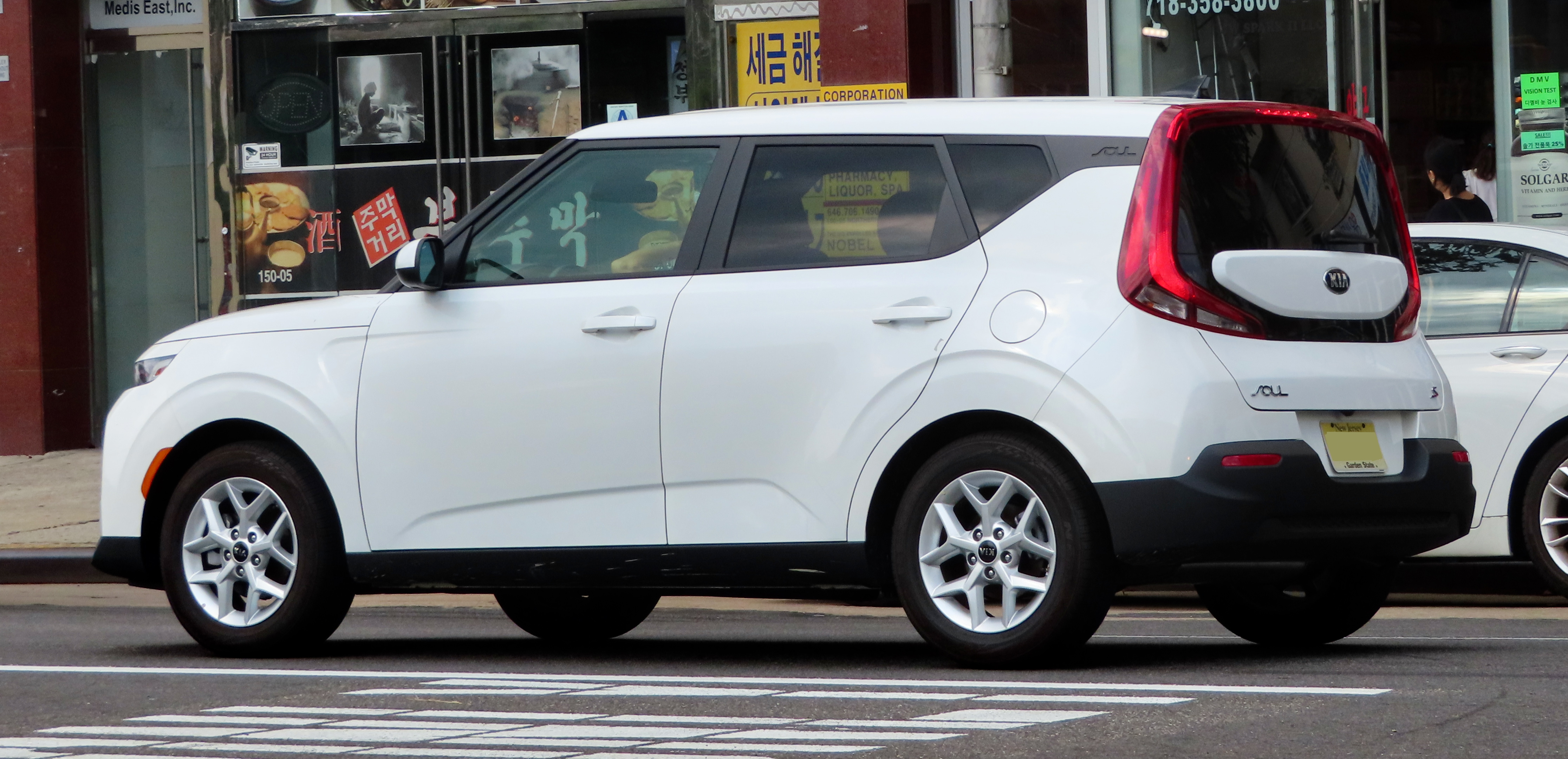 White Kia Soul parked on a city street