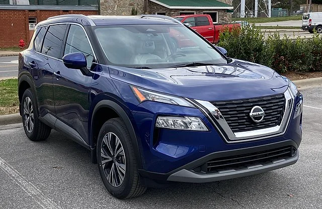 Blue Nissan Rogue in a parking lot