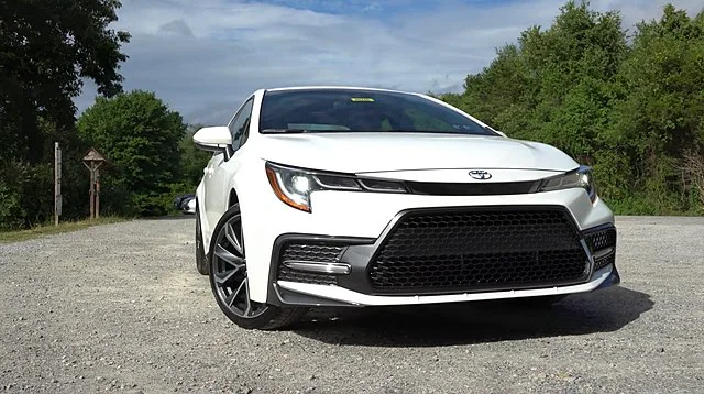 White 2021 Toyota Corolla parked near trees