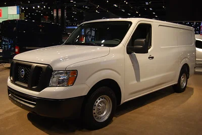 White Nissan NV Cargo at night