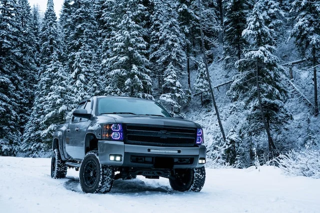 silver chevy silverado in the snow