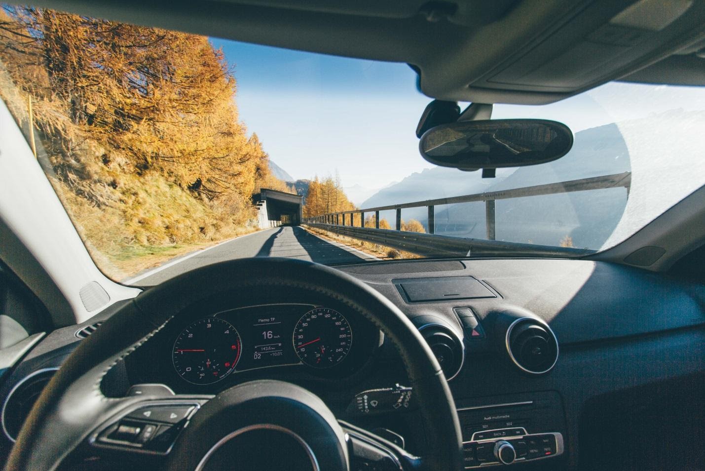 Photo of self-driving car from car interior, a steering wheel with no hands on it