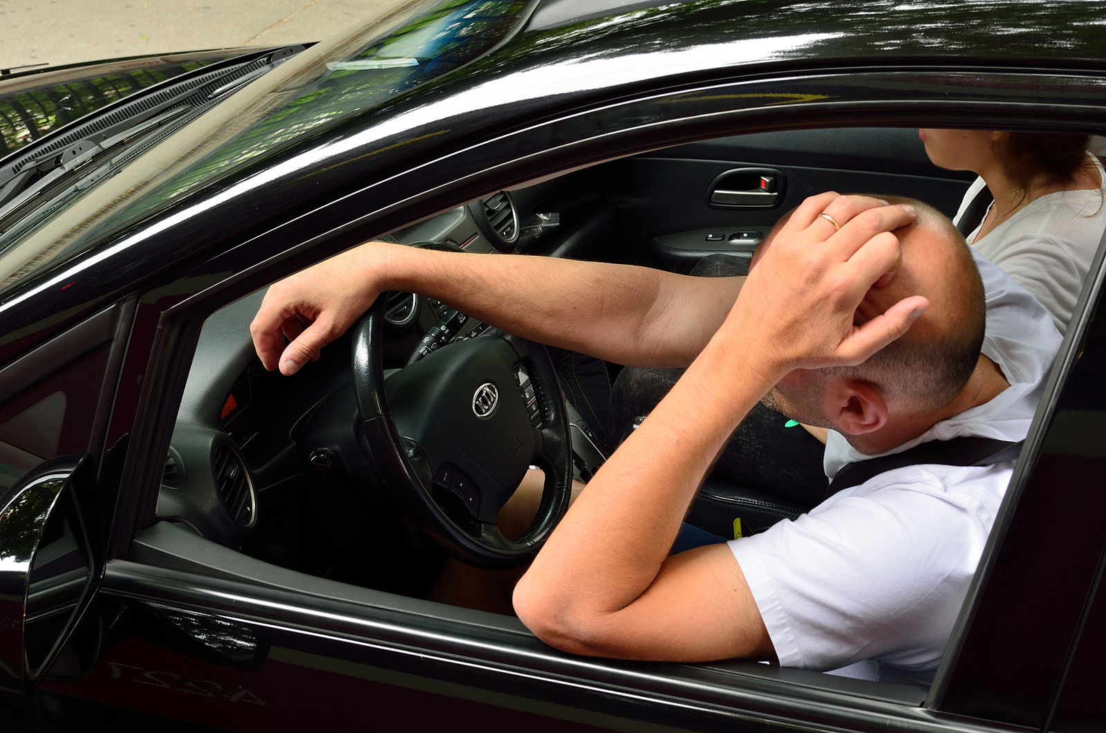 Photo of tall man in a car