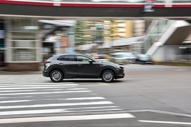 Mazda CX-30 driving quickly down a street